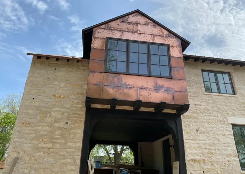 Copper metal panel facade on a stone building for Skylight Installation in Odenville